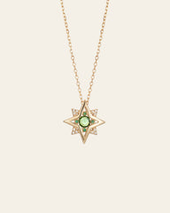 The CAMELLIA New York Emerald Pentagram Necklace is a stunning gold star-shaped pendant on a thin chain, featuring a central emerald-like gem surrounded by tiny diamonds, crafted in luxurious 14K Yellow Gold Vermeil.