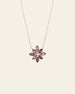 The Cámellia Garnet Pearl Necklace by CAMELLIA features a sterling silver chain with a floral pendant, highlighting garnets and gemstones in pink, red, and white.
