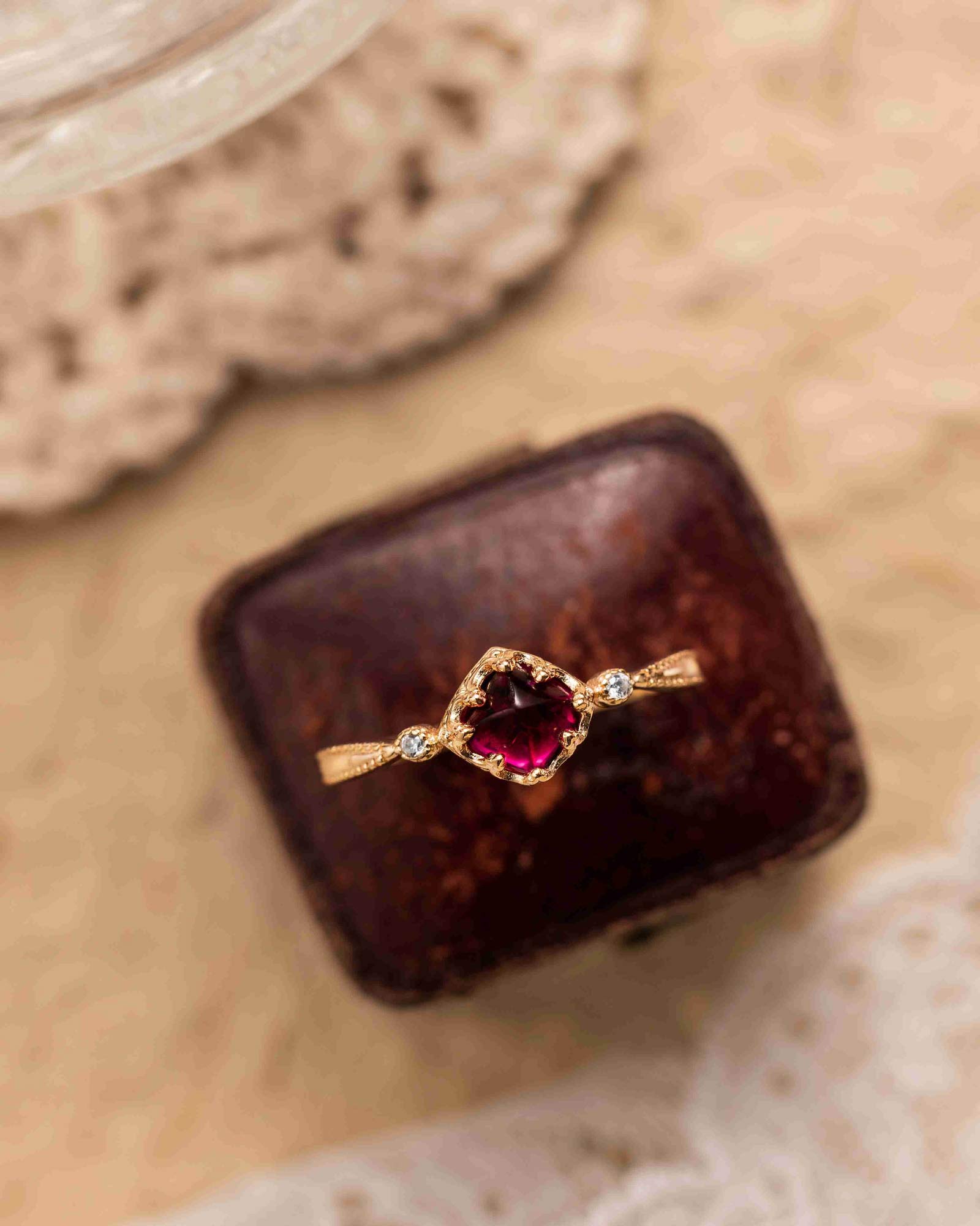 "Antique garnet ring styled with elegant wedding accessories"