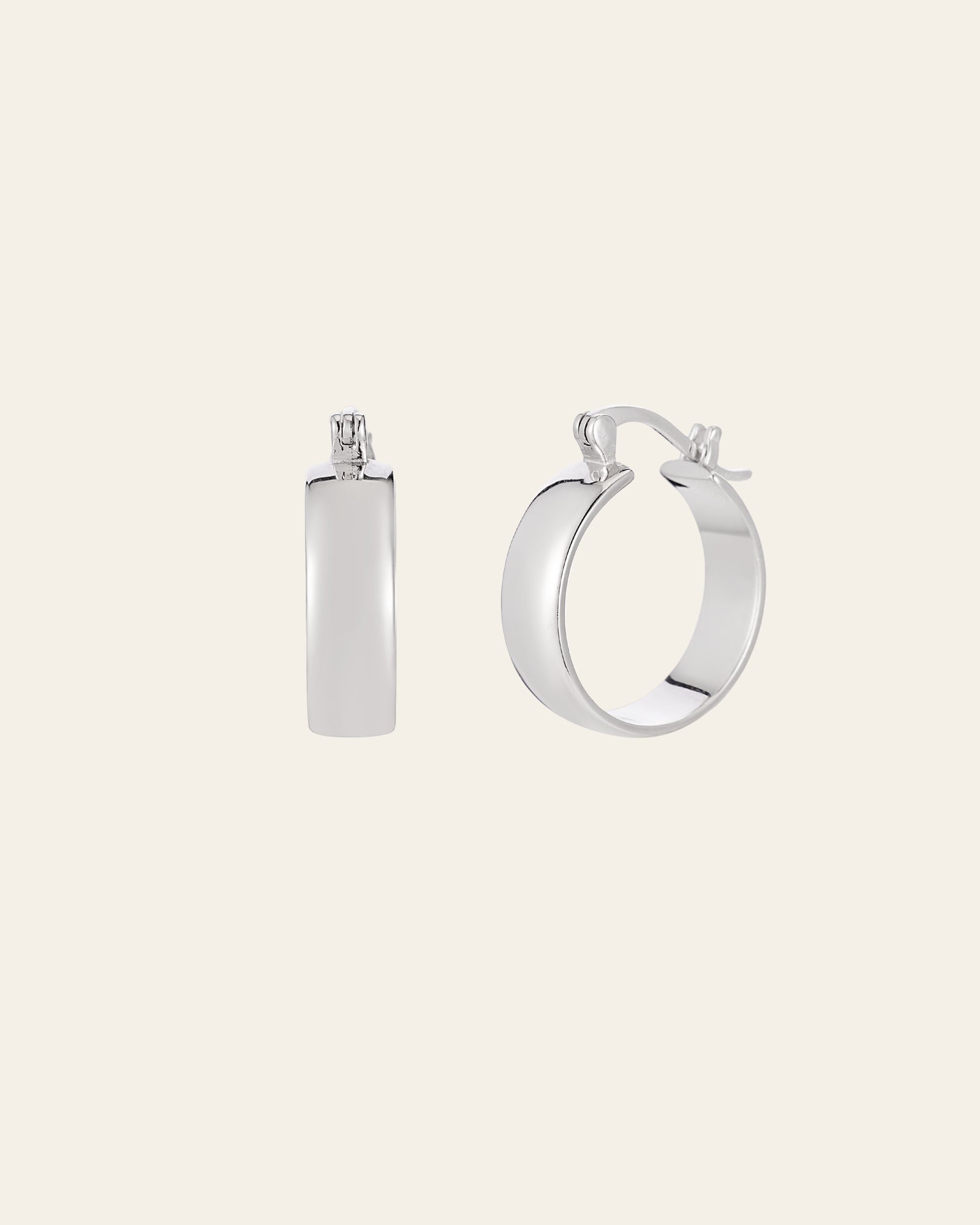 Detail: Camellia NYC Eta Hoops earrings in silver with smooth curves and understated modernity.