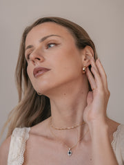 Side view: model wearing Camellia NYC Eta Hoops earrings, revealing the urban modern fashion charm.