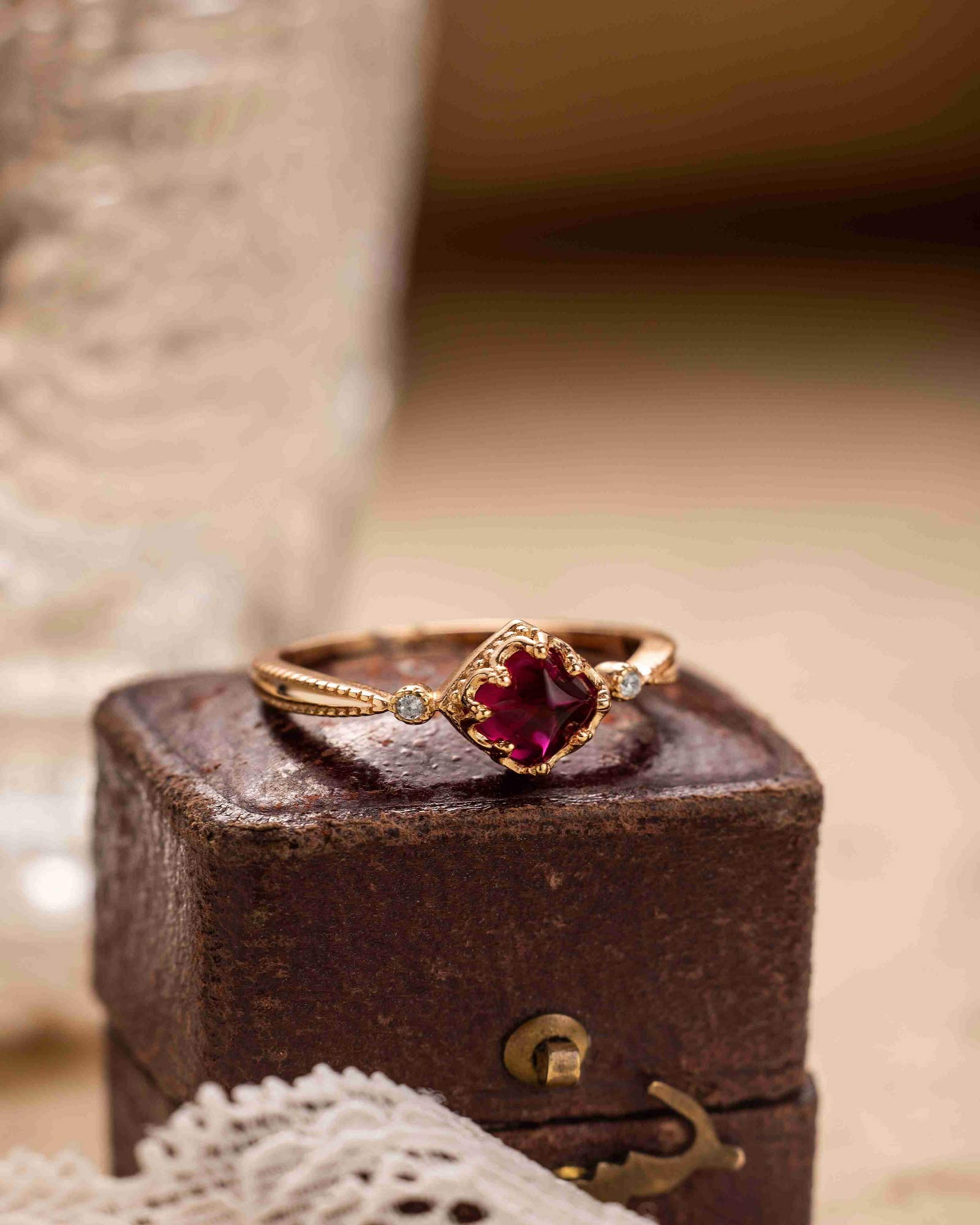 "Romantic vintage garnet ring displayed with floral decor, perfect for engagement"